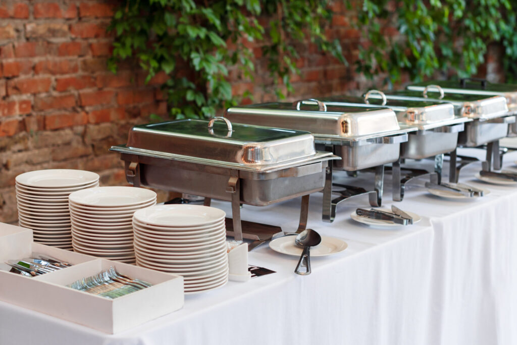 Heated buffet trays standing in line at a business event